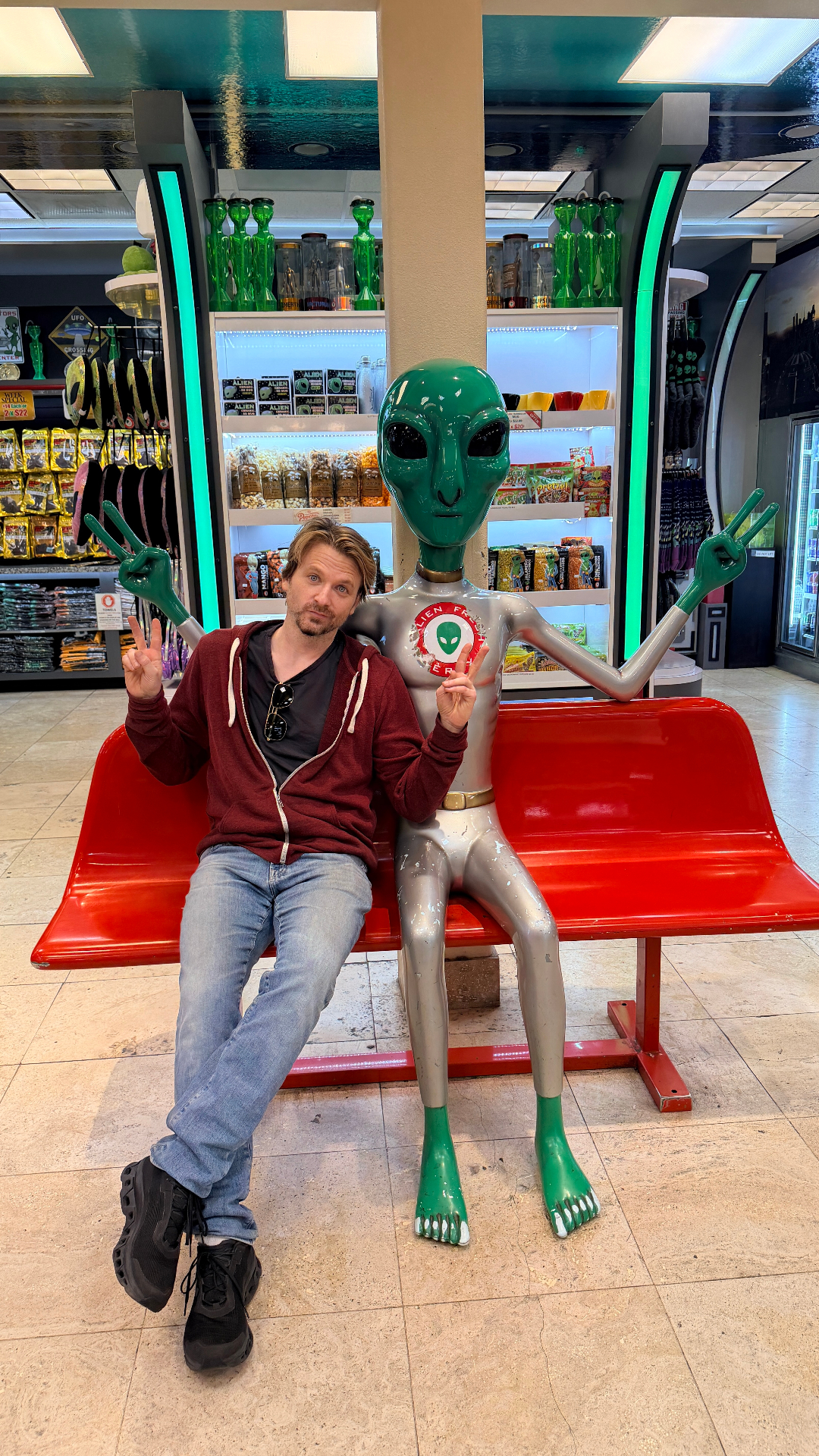 Shop Club co-founder posing with an alien at the Alien Fresh Jerky store